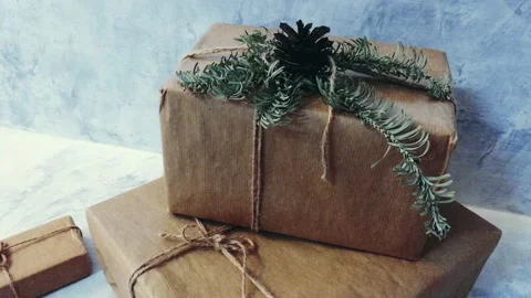 Holiday delivery boxes, parcels wrapped in brown paper, decorated and tied with Stock Footage 145646739