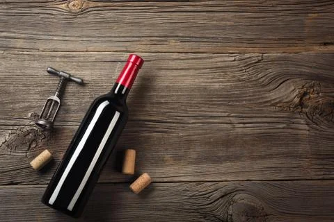 Holiday Dinner setting with red wine and gift on rustic wood. Top view with s Stock Photos