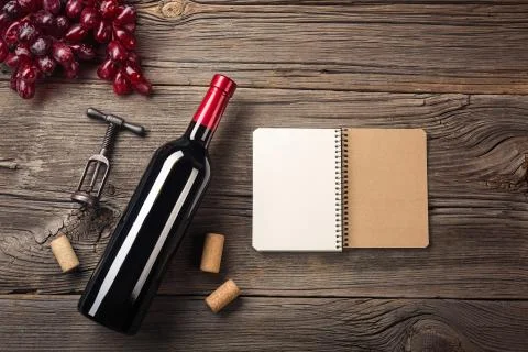 Holiday Dinner setting with red wine and gift on rustic wood. Top view with s Stock Photos
