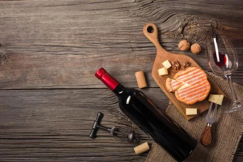 Holiday Dinner setting with red wine and creaming cheese on rustic wood. Top  Foto stock