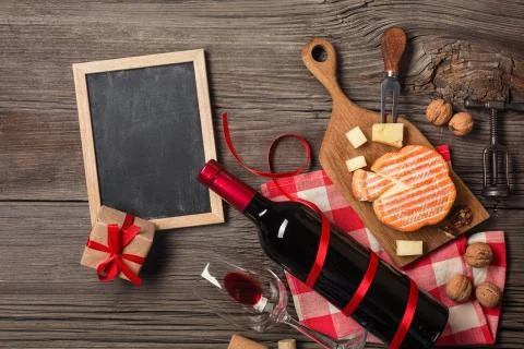 Holiday Dinner setting with red wine and creaming cheese on rustic wood. Top  Foto stock
