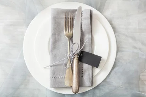 Holiday dinner. Table place setting with plates, silver fork and knife and bl Foto stock