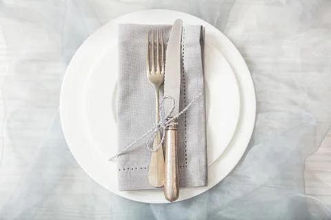 Holiday dinner. Table place setting with empty plates, silver fork and knife, Stock Photos