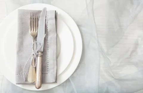 Holiday dinner. Table place setting with empty plates, silver fork and knife, Stock Photos
