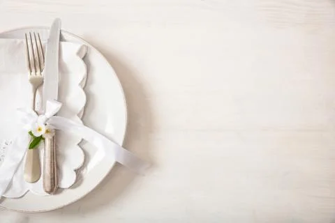 Holiday dinner. Table place setting with empty plates, silver fork and knife, Stock Photos