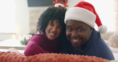 Holiday display sparking head turning in Diverse couple, embracing and laughing Stock Footage 342392132