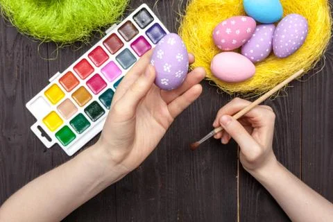 Holiday Easter hand painted eggs with chicken on the table Stock Photos