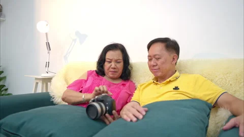 On a holiday, an elderly couple relaxes on the sofa Stockbeeldmateriaal 319533262