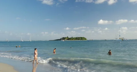 Holiday feeling for these middle aged people on sunny beach. Beautiful light, ha Stock Footage 103288011