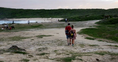 Holiday feeling for these middle aged people on the beach. Beautiful light Stock Footage 103295411