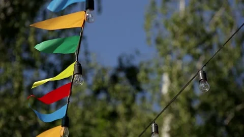 Holiday flags with light bulbs develop in the wind against the background of Stock Footage 201285499