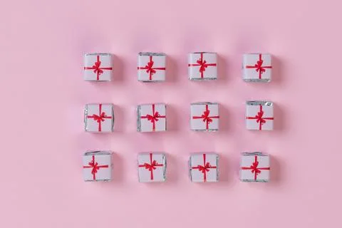Holiday flat lay with gift boxes wrapped in colorful paper and tied with bows on Stock Photos