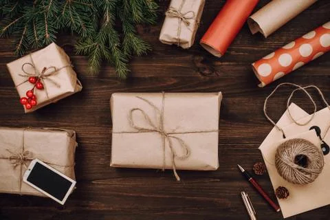 Holiday flatlay arrangement of wrapped presents on dark wooden background Stock Photos