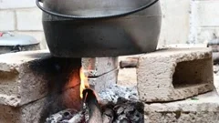 Traditional Cuisine Big Black Pot Cooking Food, Natural Fire With