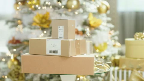 Holiday Gift Boxes on Glass Table with Christmas Tree Video stock 347031424