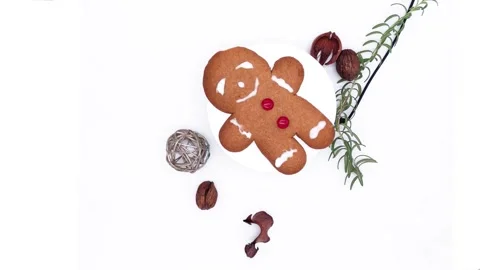 Holiday gingerbread cookie with red candy buttons, turning alongside the wa.. Stock Footage 314675048
