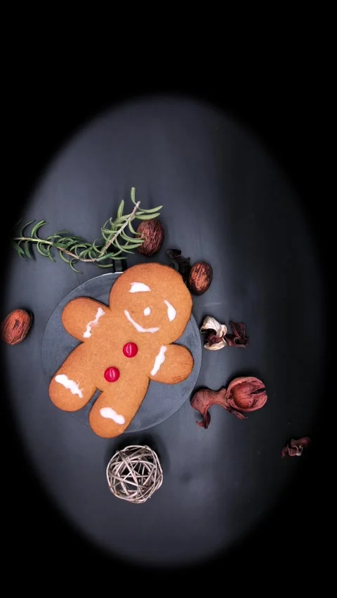 Holiday gingerbread cookie with red candy buttons, on black background turning a Stock Footage 314675056