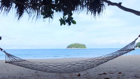 Holiday hammocks at the beach in a hammock on a summer holiday Stock-Footage 109155384