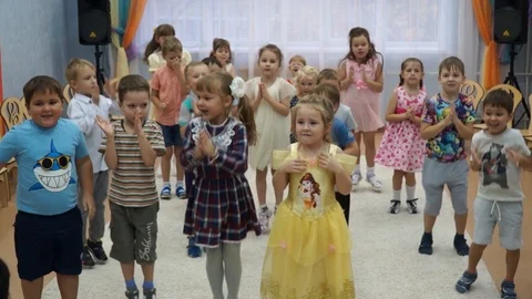 Holiday in kindergarten. Children dance, sing songs. This is a performance fo Stock Footage