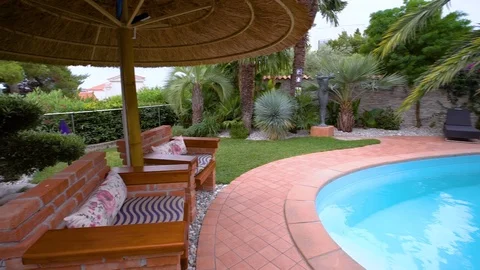 Holiday location with palm trees, pool and greenery   Stock Footage 111022855