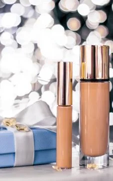 Holiday make-up foundation base, concealer and blue gift box, luxury cosmetic Stock Photos
