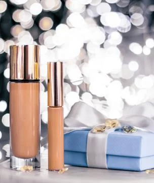 Holiday make-up foundation base, concealer and blue gift box, luxury cosmetic Stock Photos