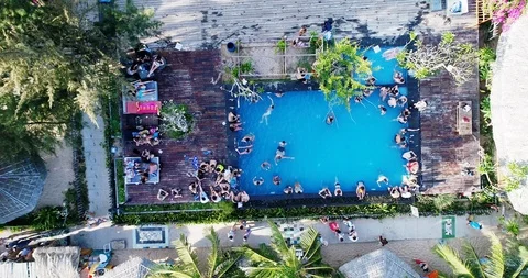 Holiday makers pack into a pool at a resort by the beach in Asisa. Stock Footage 124472392