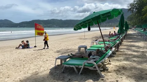 Holiday makers relax in Patong beach, Phuket island, Thailand 4K Video stock 195157341