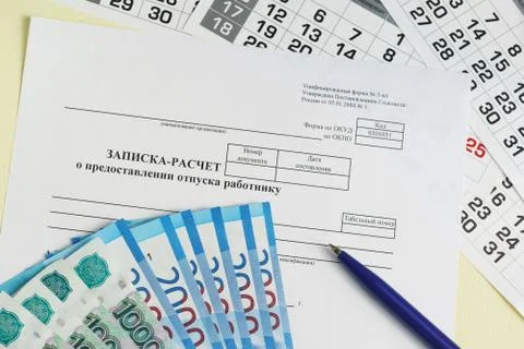 Holiday pay. Note-calculation on granting of holiday to the worker, pen and t Stock Photos