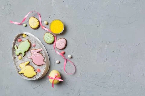 Holiday preparation Multi colors Easter eggs with cookies on colored backgrou Stock Photos