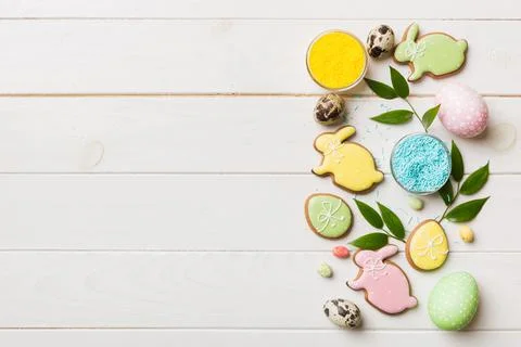 Holiday preparation Multi colors Easter eggs with cookies on colored backgrou Stock Photos