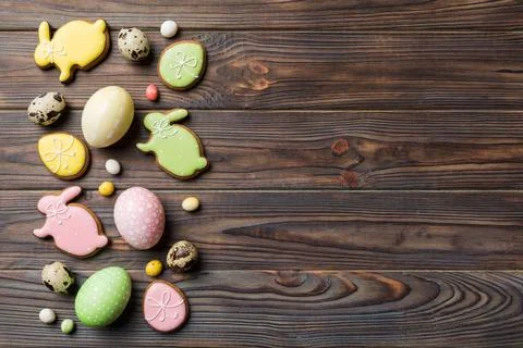 Holiday preparation Multi colors Easter eggs with cookies on colored backgrou Stock Photos