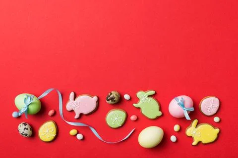 Holiday preparation Multi colors Easter eggs with cookies on colored backgrou Stock Photos