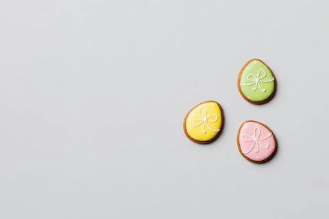 Holiday preparation Multi colors Easter eggs with cookies on colored backgrou Stock Photos