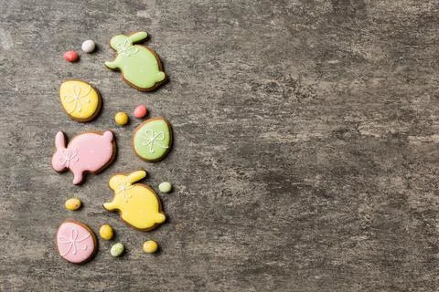 Holiday preparation Multi colors Easter eggs with cookies on colored backgrou Stock Photos