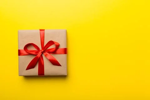 Holiday present box over colored background, top view. Copy space for design Foto stock