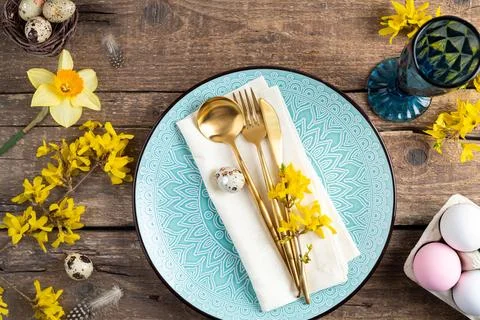 Holiday table setting with Easter decorations, spring flowers and gold cutl.. Stock Photos