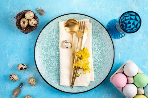 Holiday table setting with Easter decorations, spring flowers and gold cutl.. Stock Photos