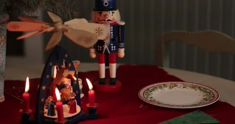 Holiday table setting featuring a nutcracker and candle centerpiece for festive Stock Footage 311936041