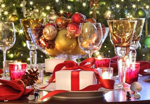 Holiday table setting with red ribboned gift Stock Photos