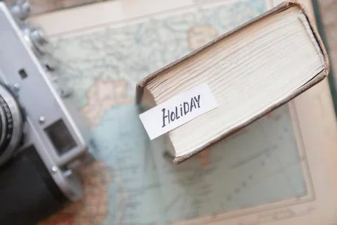 Holiday text and a map with a camera Stock Photos