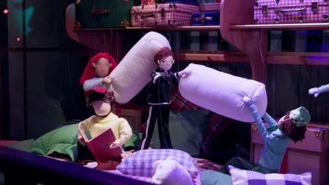 Holiday-themed puppet display with vibrant colors, playful pillow fight, and Vídeos de archivo 295331785