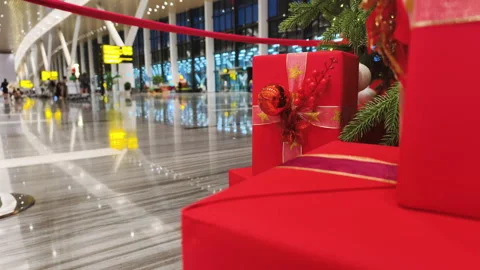 Holiday Travel Decor includes red boxes under tree. Bright Holiday Travel Decor Stock Footage 325771096