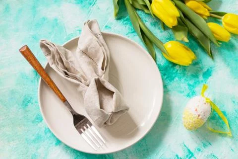 Holidays background. Easter table setting with tulips flowers. Stock Photos