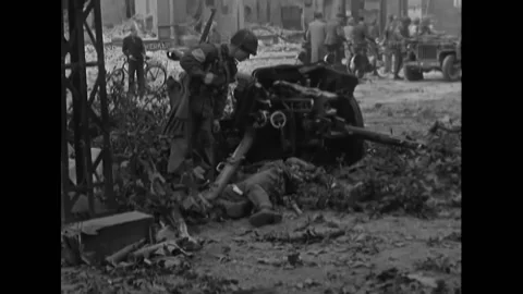 HOLLAND - 1944 - US troops fire towards enemy, check deceased bodies on ground, Stock Footage 296758098