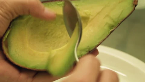 Hollowing Out Avocado with Spoon Stock Footage 154760644