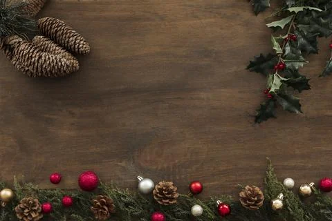 Holly branches with cones on table. High quality photo Stock Photos