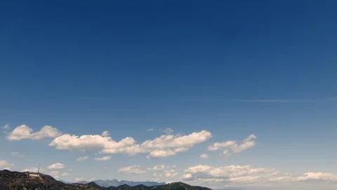 Hollywood sign, mountain range with soft clouds above Stock Footage 100747345