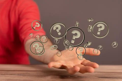 Hologram of 3D rendered question mark signs and person behind holding them in hi Stock Photos