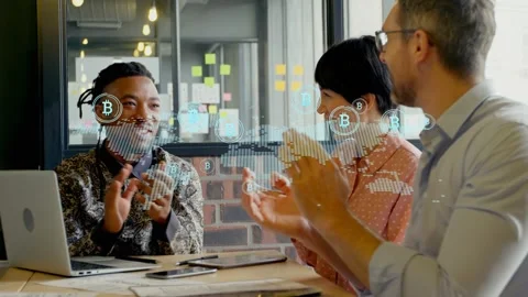 Hologram map appearing over table, team clapping laptop visible, B icons growing Stock Footage 333689729